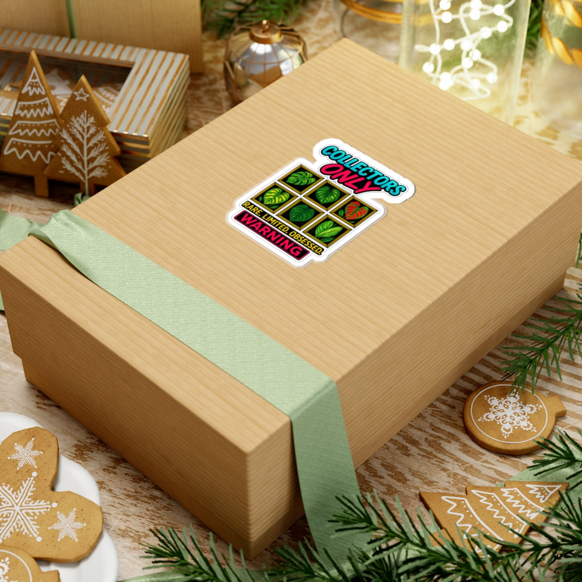 Wooden gift box with a green ribbon and a sticker on a festive background with cookies and lights.