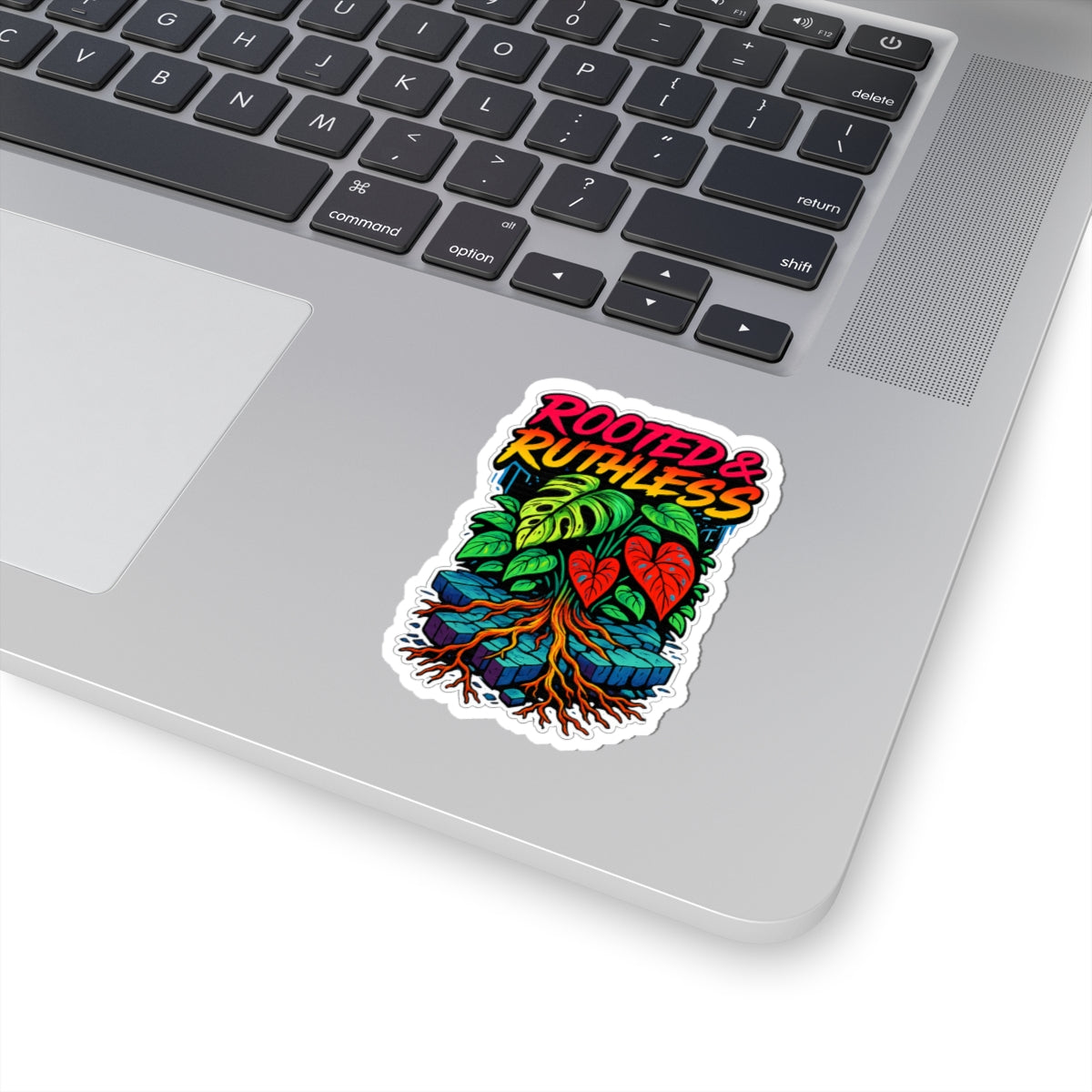 Laptop with a colorful sticker featuring leaves and text on the palm rest area.