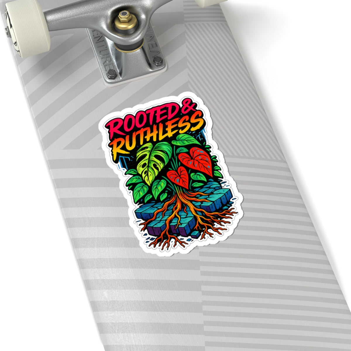 Skateboard with a colorful 'Rooted & Ruthless' sticker on a white background